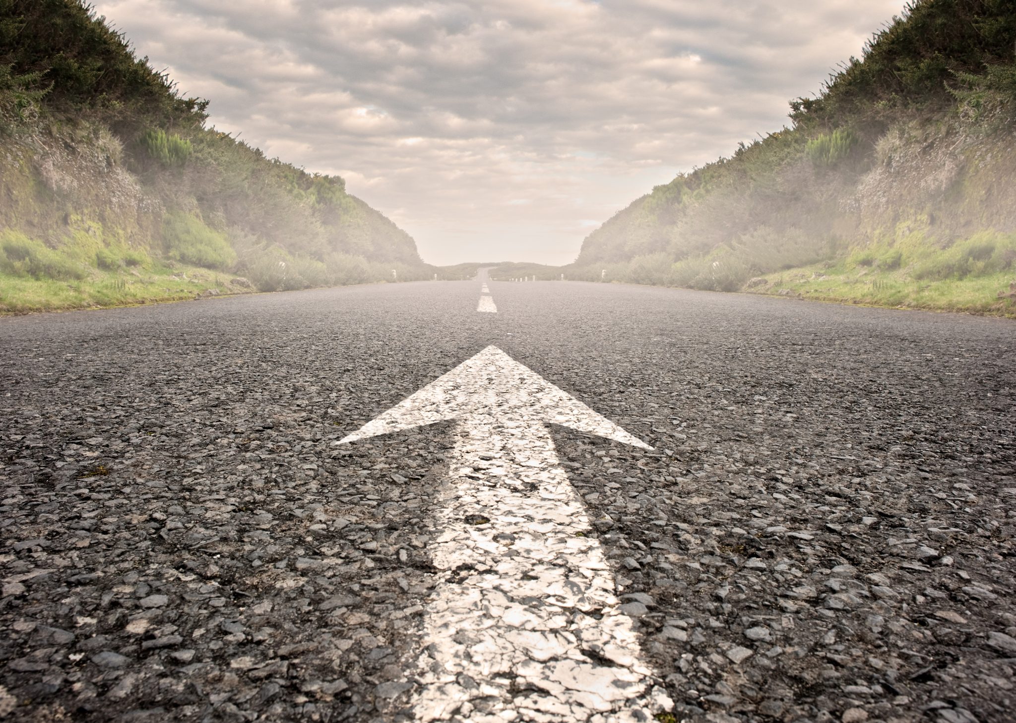 bigstock-arrow-on-asphalt-road-to-the-h-55561178